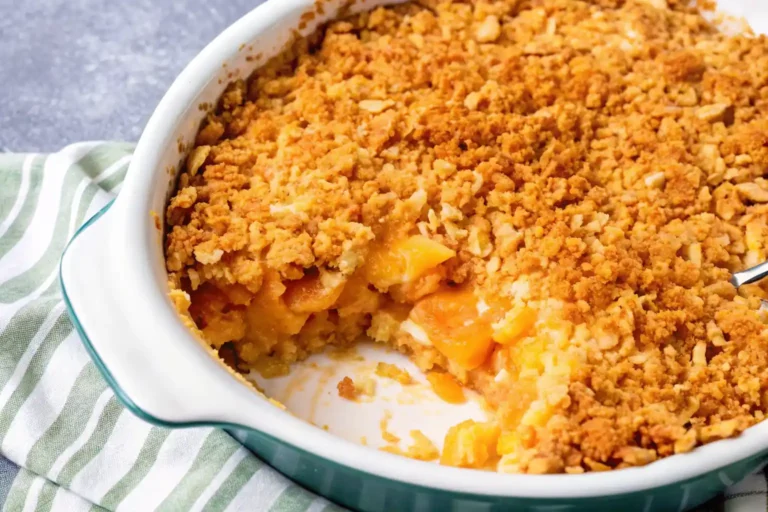 A freshly baked pineapple casserole with a golden, crumbly topping, and a portion removed to reveal the sweet pineapple filling.