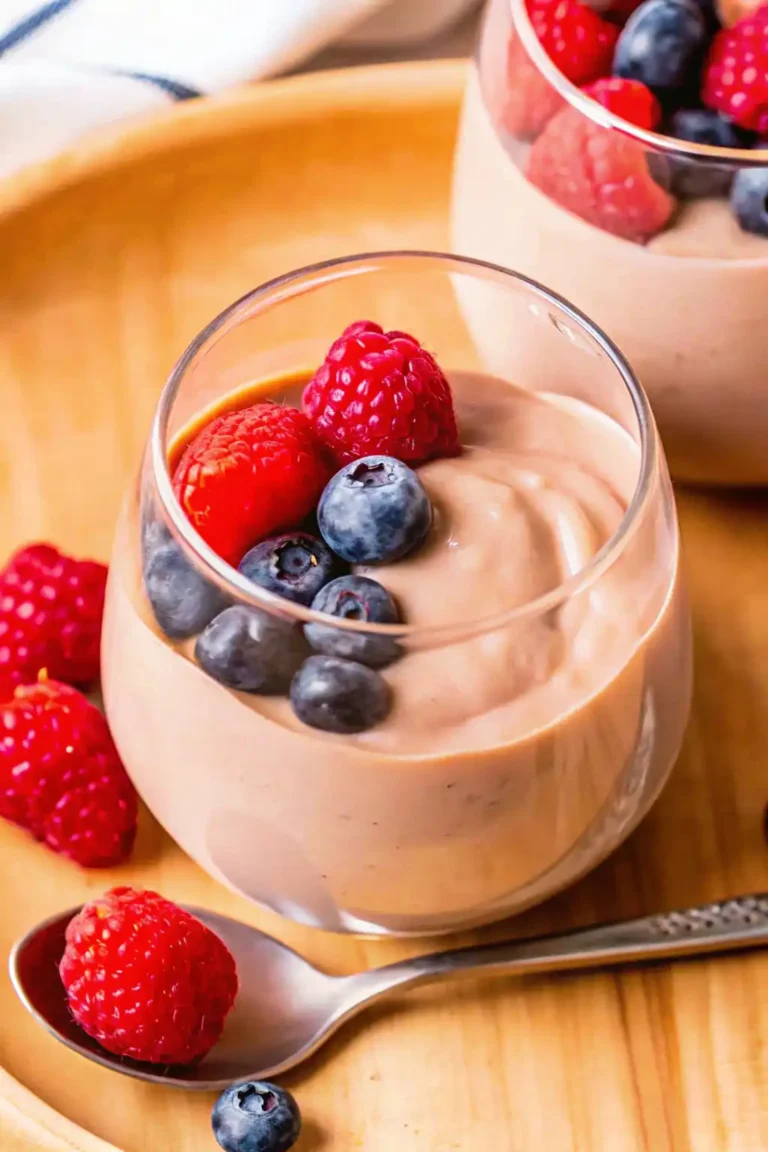 Protein pudding with berries and a spoon.